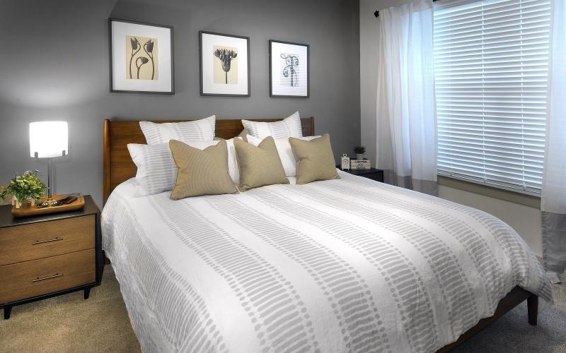 a bed with a white and brown comforter