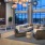 a room with a large window and a couch and a table with chairs