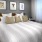 a bed with a white and brown comforter