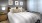 a bed with a white and brown comforter