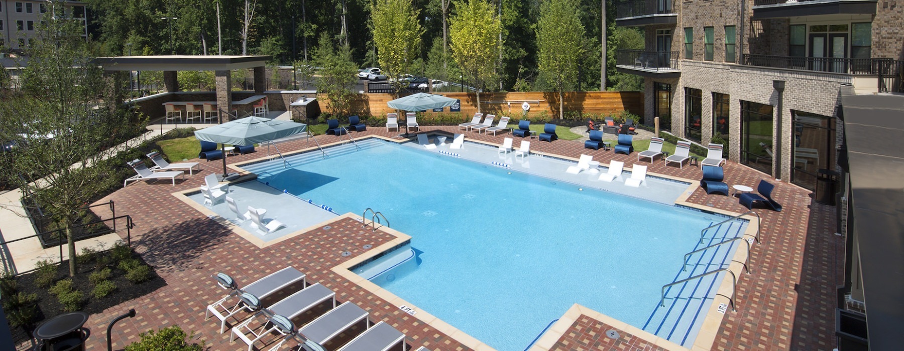 pool showing reclining seating and nearness to property buildings